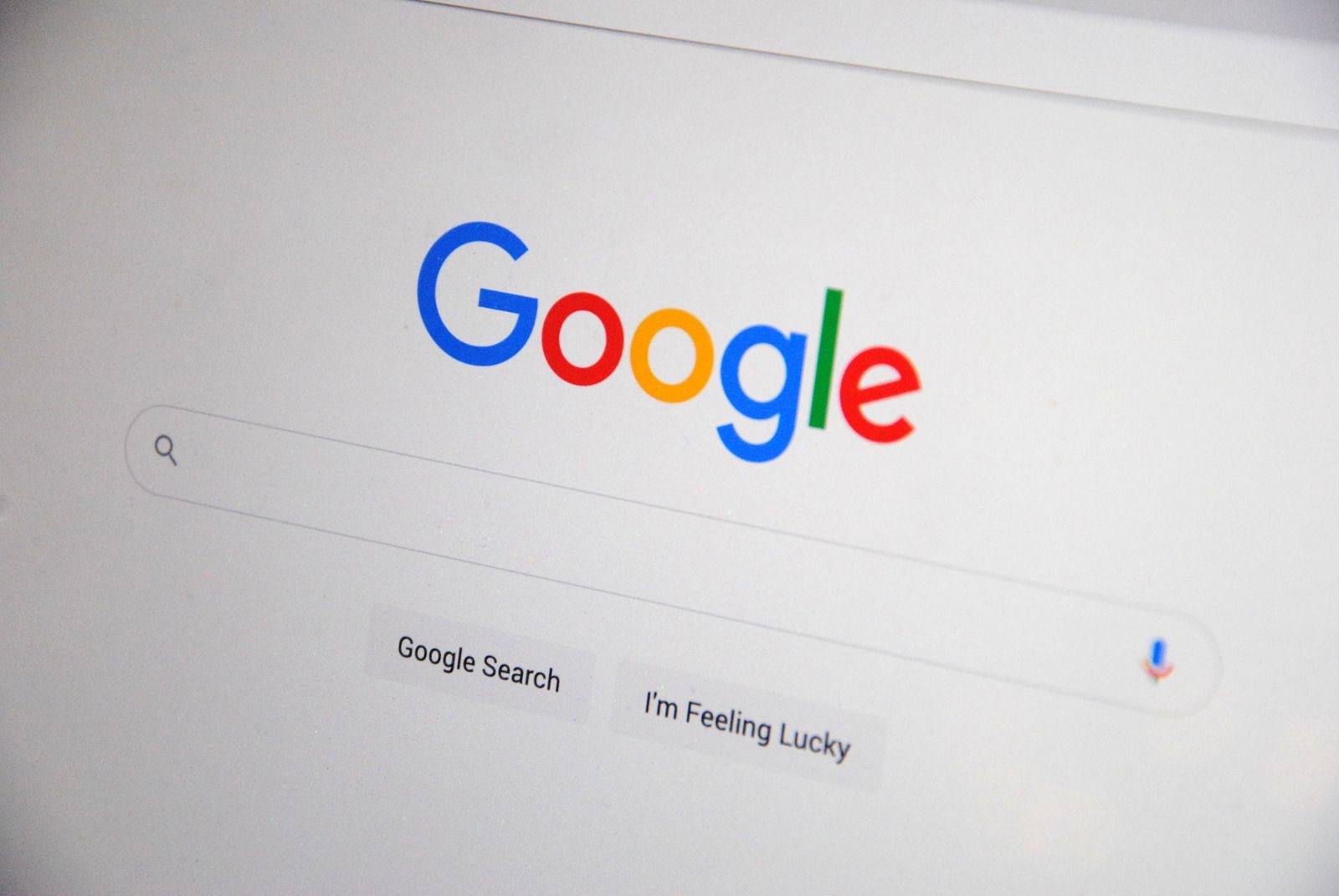 Close-up of the Google search engine homepage displayed on a screen, illustrating a search results and AI overview interface