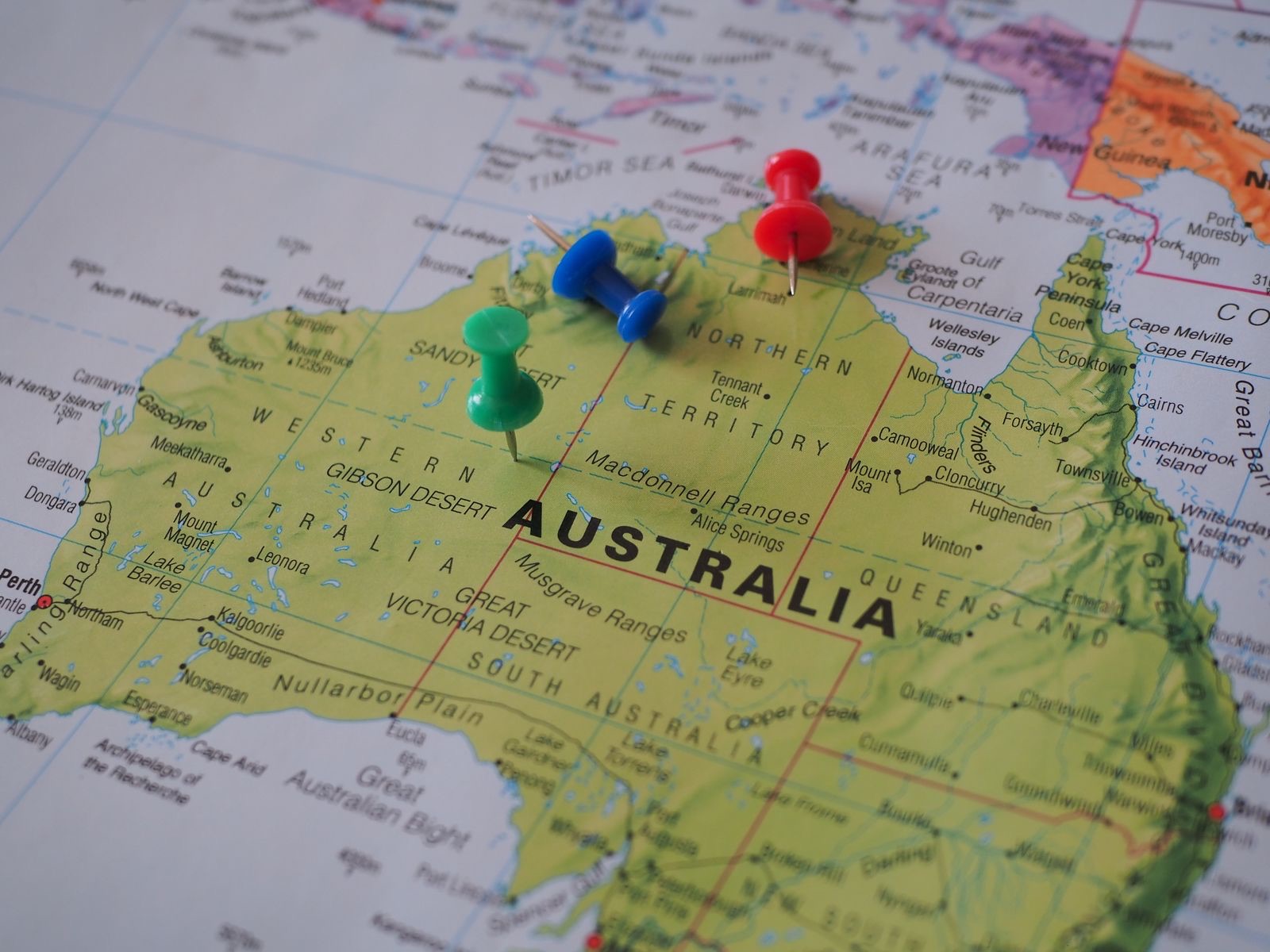 Close-up of a map of Australia marked with multiple colorful pushpins indicating several business locations